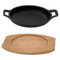 REGENT COOKWARE CAST IRON OVAL PAN WITH 2 HANDLES ON A WOODEN BOARD, (225X120X55MM)