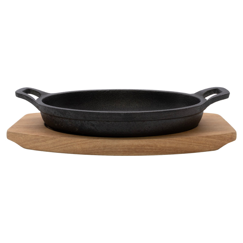 REGENT COOKWARE CAST IRON OVAL PAN WITH 2 HANDLES ON A WOODEN BOARD, (225X120X55MM)