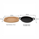 REGENT COOKWARE CAST IRON OVAL PAN WITH 2 HANDLES ON A WOODEN BOARD, (225X120X55MM)