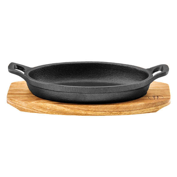 REGENT COOKWARE CAST IRON OVAL PAN WITH 2 HANDLES ON A WOODEN BOARD, (225X120X55MM)